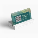 A marble business card holder, holding up to 25 business card, promoting an interior design business with a QR code printed on the front.