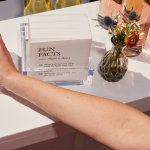 A collection of cocktail napkins personalized for a wedding, printed with fun facts about the bride and groom.