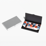 A closed silver aluminum business card holder and an open black business card holder showing business cards for a wine brand.