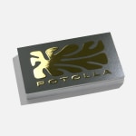 A business card printed with a raised foil logo and text.