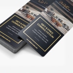 A stack of gold embossed foil rack cards advertising a free consultation for a real estate company.