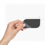 A person holding a leaf business card, labeled by its size.