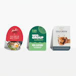 Oval, half-circle and leaf-shaped postcards, all propped up against a wall and advertising different restaurants.
