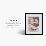 A framed print featuring a photo of a child and man hugging.