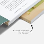 A close-up of a perfect bound book’s glued spine, with a written note, "A sturdy, glued spine for durability."