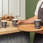 3 different sizes of our custom paper coffee cups next to each other.