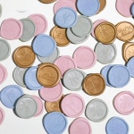 A pile of custom wax seals in a variety of colors and motifs.