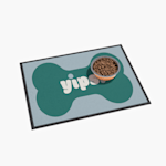 A dog bone floor mat with a dog bowl filled with food on it.