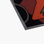 The bottom left corner of a colorful logo floor mat.