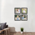 Four framed canvas prints of a family hanging on a living room wall. 
