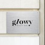 A beauty bar metal sign hanging on a wall.