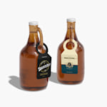 2 growler bottles displaying growler tags for beer companies.