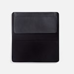 A black leather checkbook cover with a writing flap lying open on a white background.