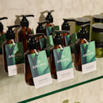 A variety of hang tags on soap bottles promoting a linen mist scent.