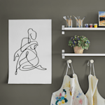 A wall poster printed with a graphic design featured in a craft room.