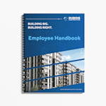 A wire-bound employee handbook for a construction company with a blue cover featuring residential building imagery.