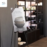 A beginner potter class foam board on an easel standing next to a shelf of pottery, with a 24-hour delivery icon in the corner.