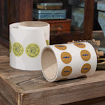 A roll of labels cut to a custom shape of 2 donuts from a cafe.