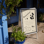 An aluminum A-Frame promoting a cafe.