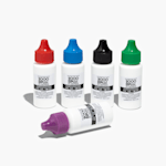 A red stamp pad outside of its case alongside a bottle of blue refill ink.