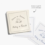 A stack of white and ecru cocktail napkins customized for a wedding, with a note that ecru and white colors are available. 