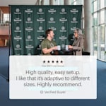  A man and a woman having coffee in front of a step & repeat banner with a logo and business name printed all over it. A customer review reads: “High quality, easy setup. I like that it’s adaptable to different sizes. Highly recommend.”