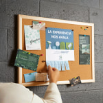 A perforated flyer on a corkboard has multiple tabs missing as people take them to use later.