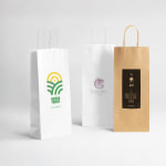 Two white wine bags and a brown wine bag all display their custom logos.