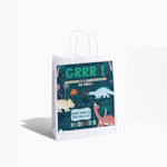 Un sac en papier blanc orné d’étoiles dorées, avec un texte célébrant un 60e anniversaire.