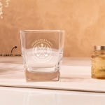A tumbler personalised for a golf tournament, with a text call out that reads; "made from high-quality glass".
